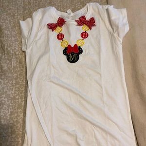 A Mickey Mouse shirt with M on front. This is a kids large